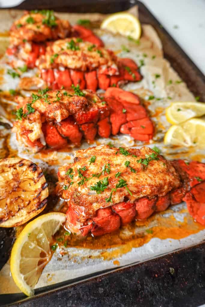 cooked lobster tails on a baking sheet