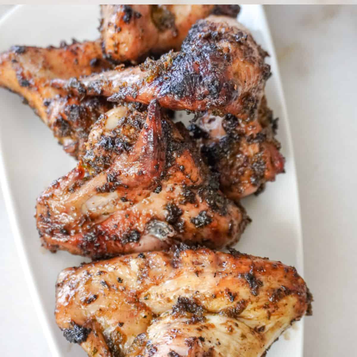 grilled chicken that is sitting on a white plate