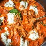 a spoonful of lasagna over a pot of skillet lasagna