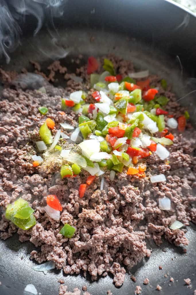 ground beef topped with diced aromatics