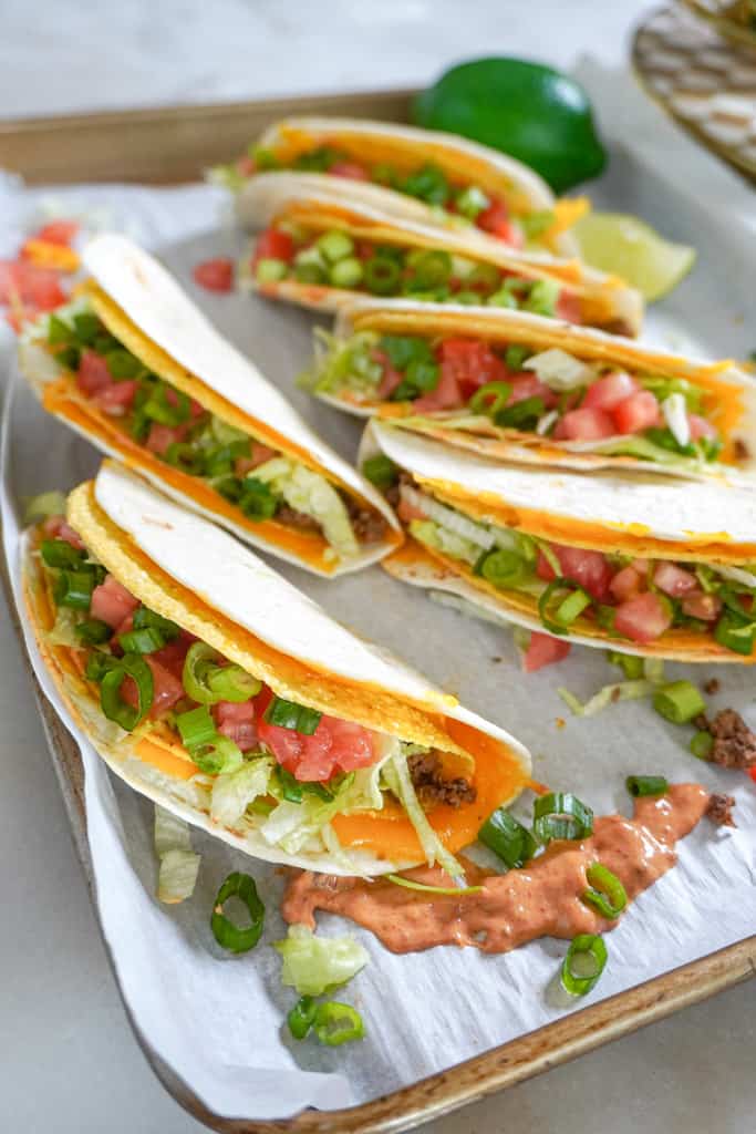 cheesy gordita crunch tacos on parchment paper
