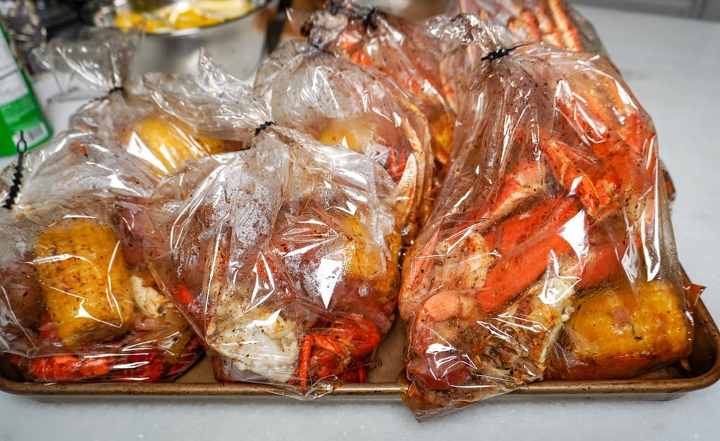 baking tray full of seafood boil bags