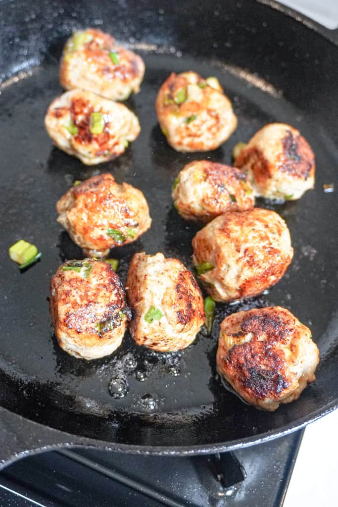 meatballs cooking in a pan