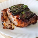 close up view of plated and sliced baked pork chop