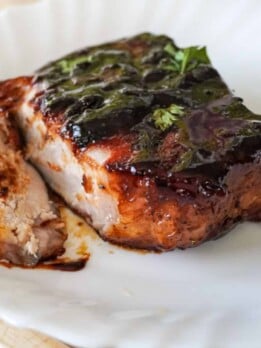 close up view of plated and sliced baked pork chop