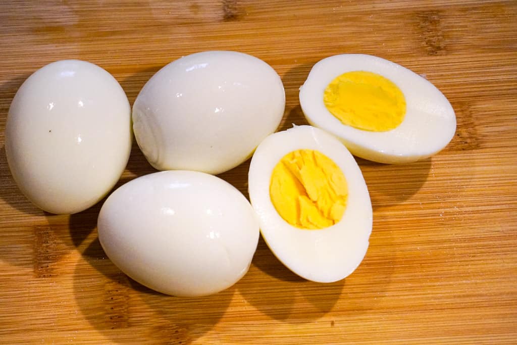 hard boiled eggs with one egg sliced in half