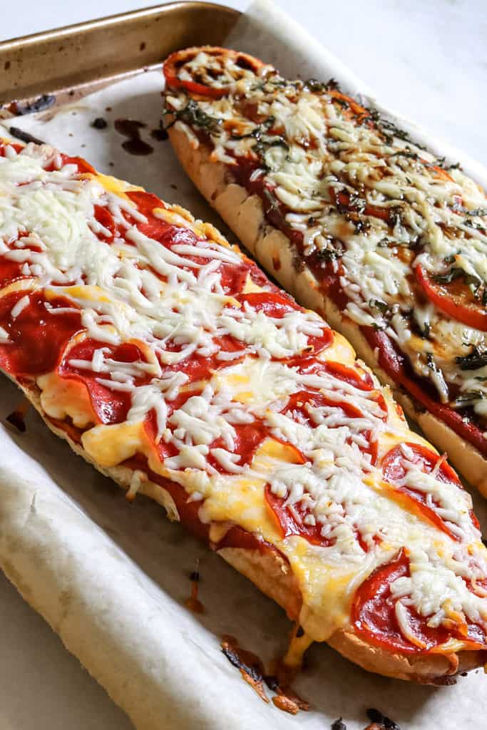 french bread pizzas on a baking tray