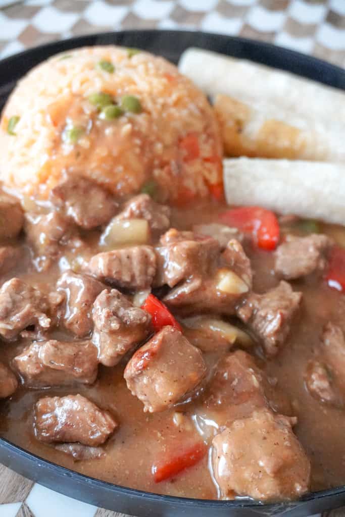 plated mexican beef stew with rice and tortillas