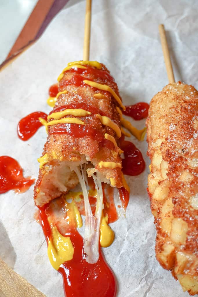 sliced open korean corn dog on parchment paper