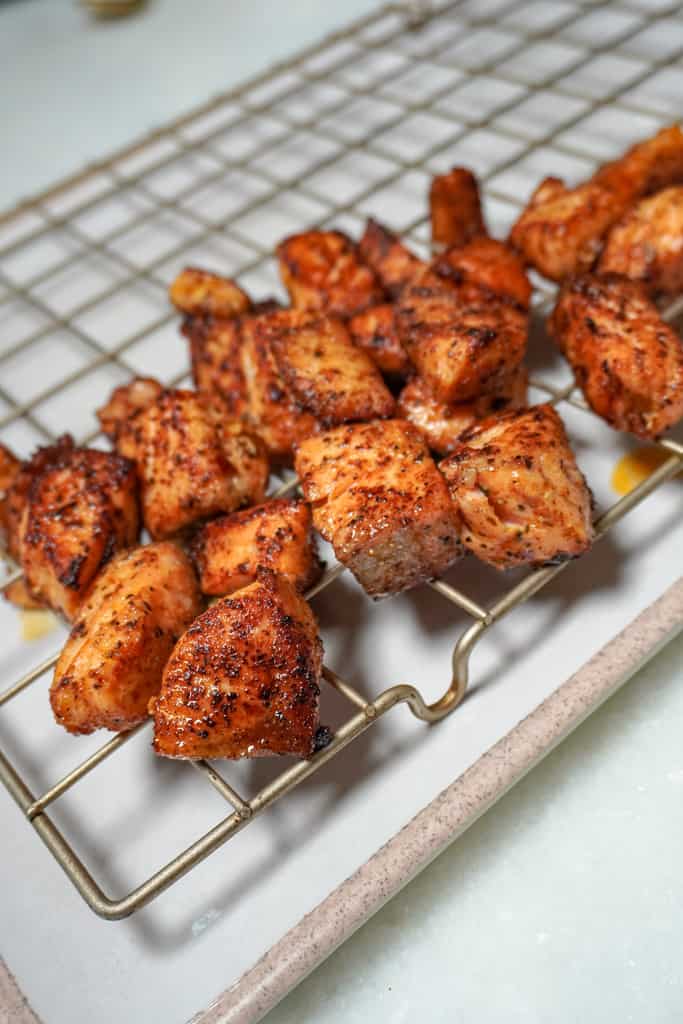 cooked salmon bites on a cooling rack