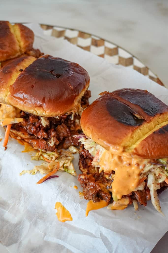 brisket sandwiches on a parchment paper lined plate