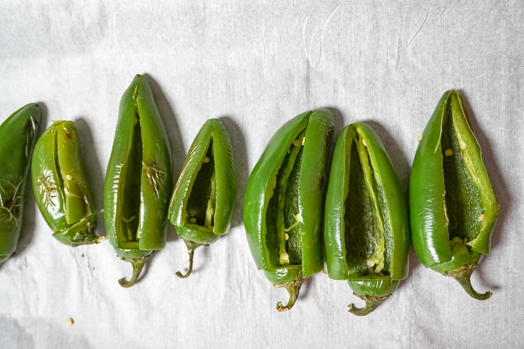 jalapeños sliced lengthwise on parchment paper