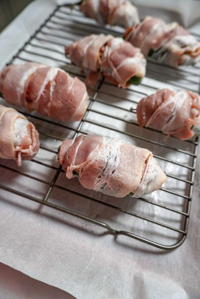 uncooked Texas Twinkies on a baking rack over parchment paper