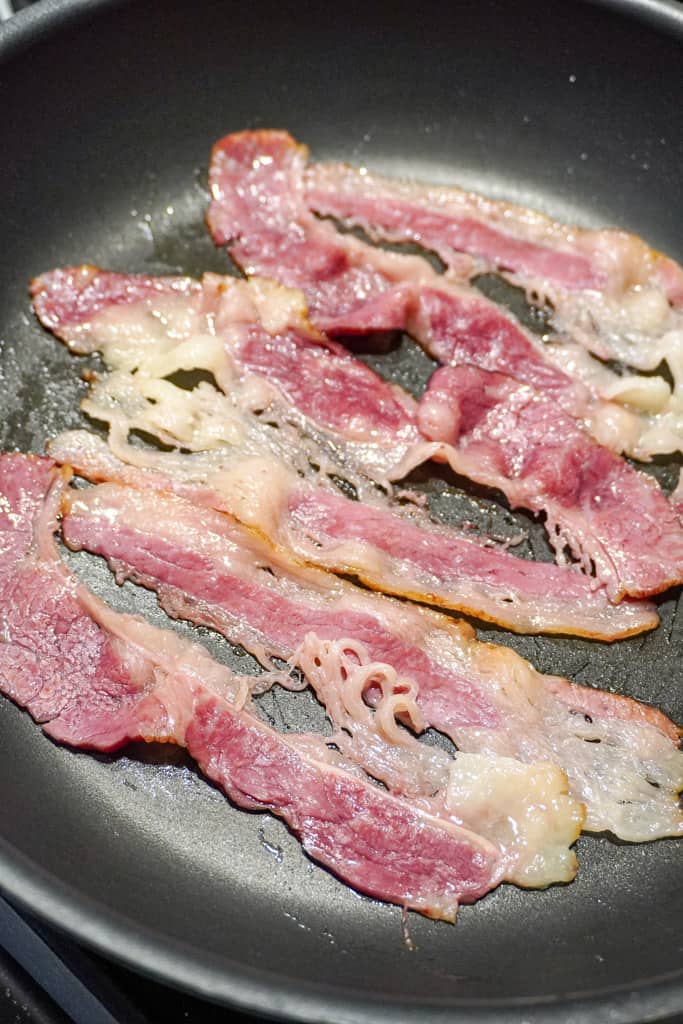 bacon frying in a skillet