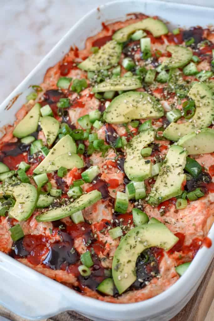 close up view of a casserole dish full of salmon sushi bake