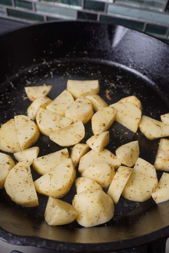 potatoes frying in a skillet