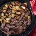 steak and potatoes in a skillet