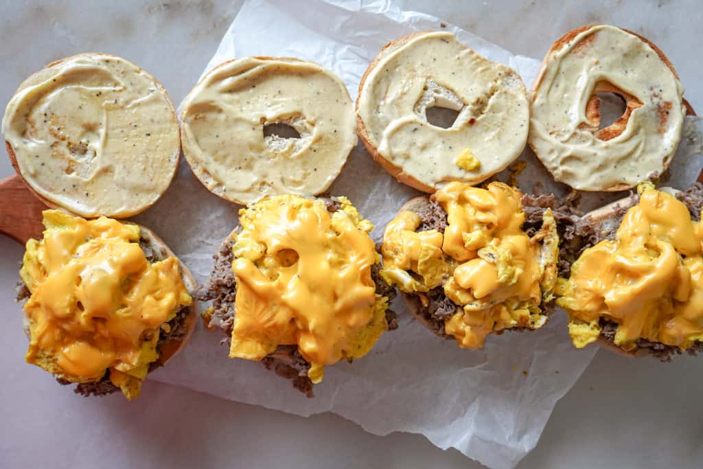 overhead view of assembled steak egg and cheese bagels