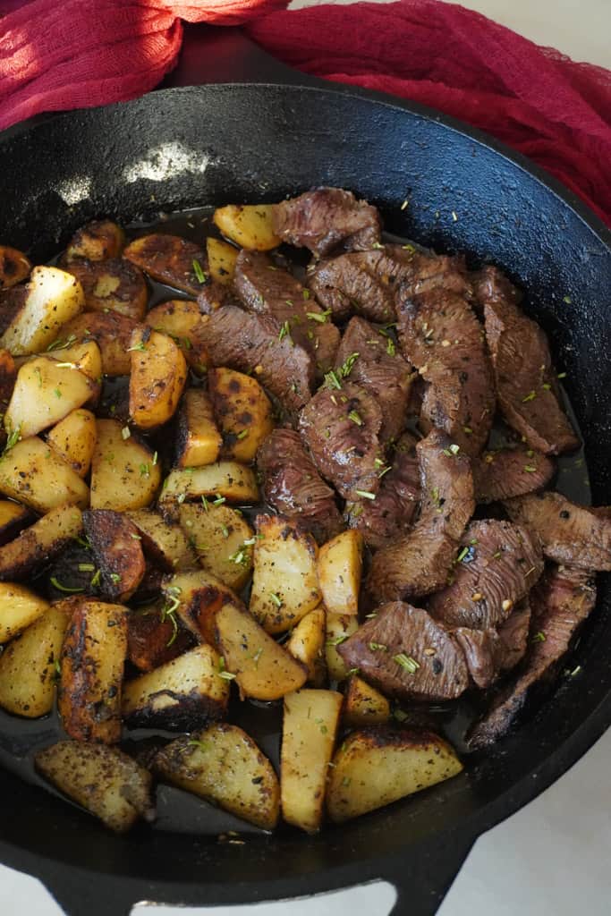 steak and potatoes in a skillet
