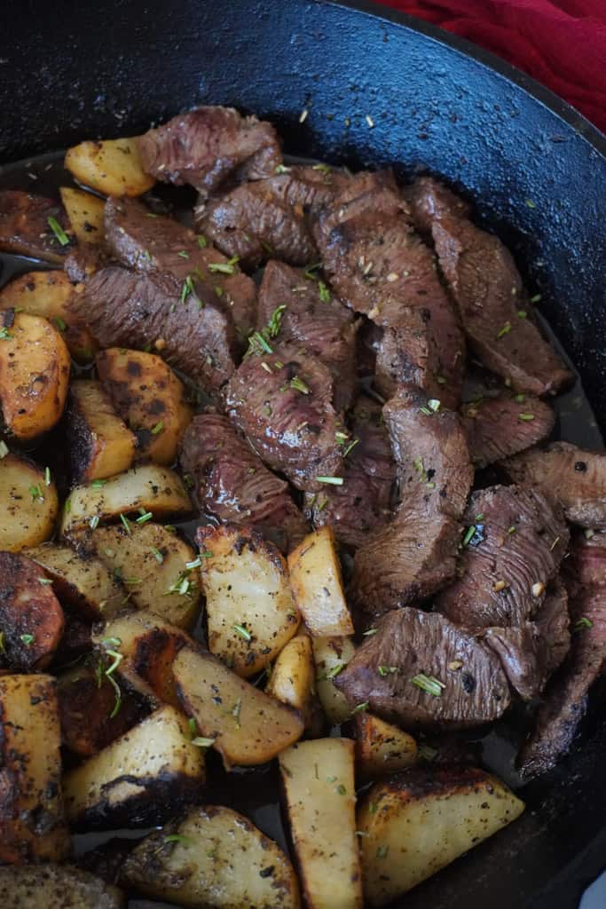 steak and potatoes in a skillet