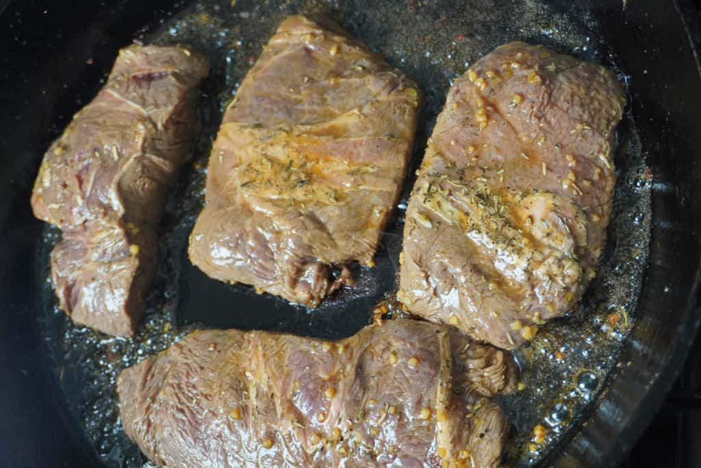 steak cooking in a pan