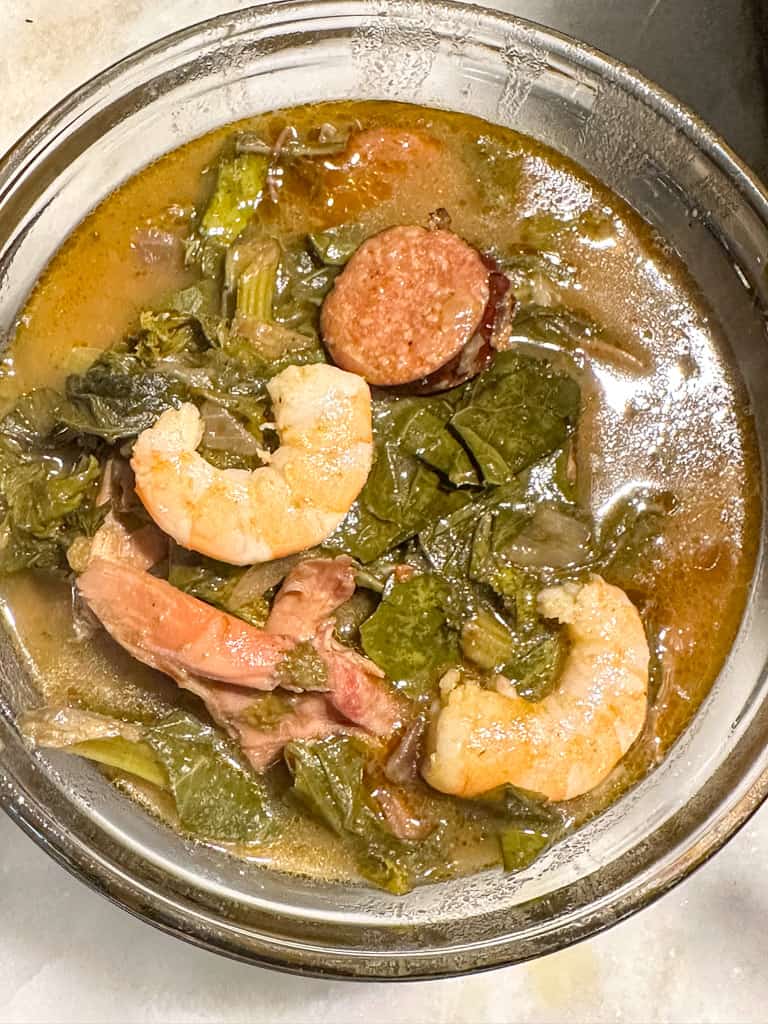 gumbo greens in a bowl with shrimp greens, sausage, and turkey meat