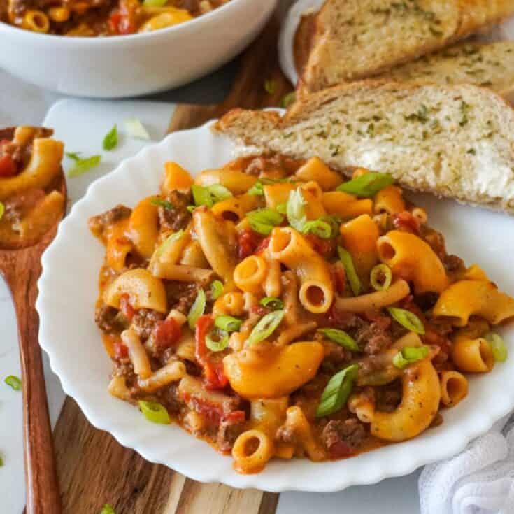 beefaroni on plate with garlic bread on the side