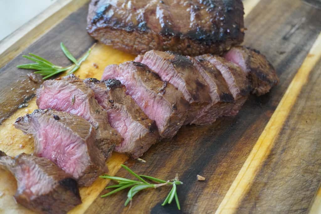 sliced steak on a cutting board
