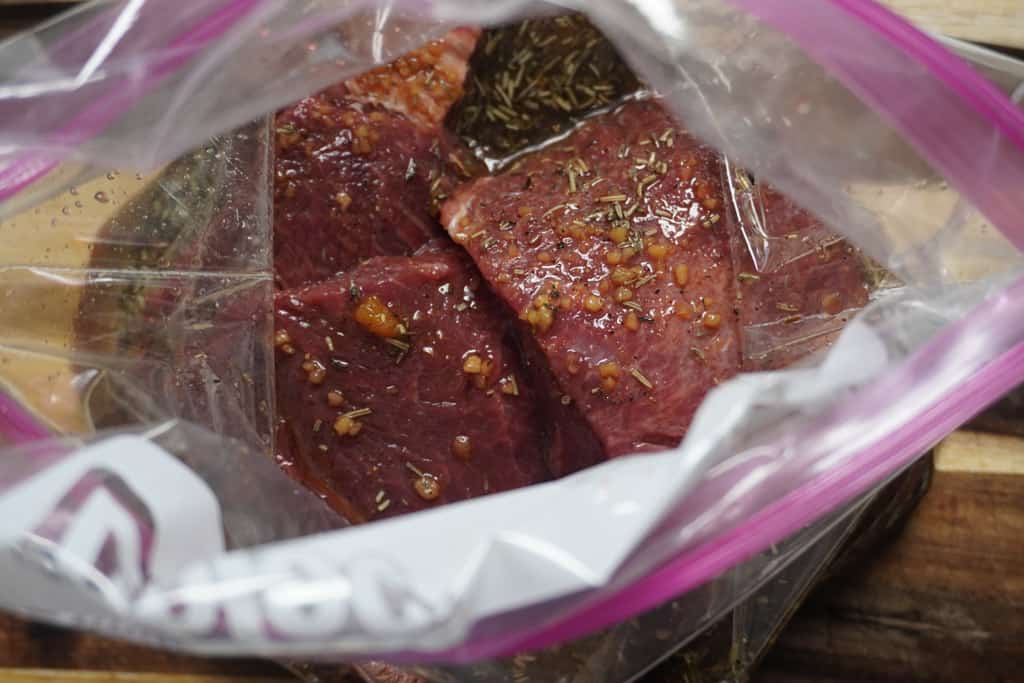 close up view of marinated steak in a bag