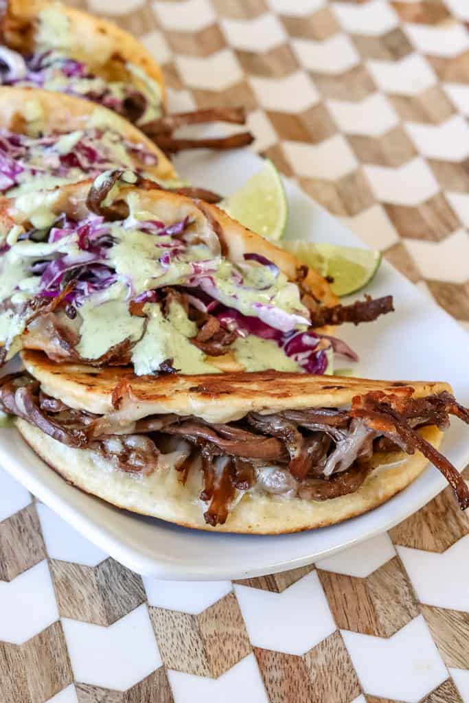 plated brisket tacos drizzled with chuy's jalapeno ranch