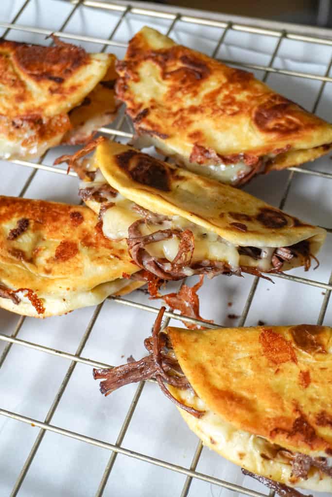 crispy brisket tacos on a cooling rack