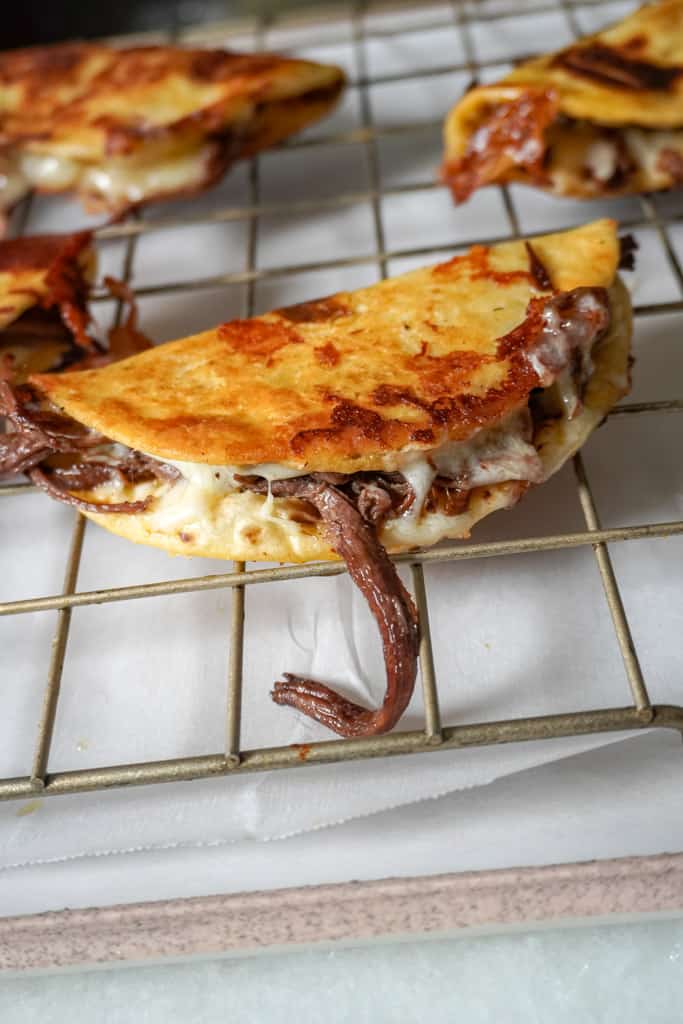 crispy brisket tacos on a cooling rack