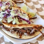 plated brisket tacos drizzled with jalapeno ranch