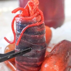 close up view of chamoy pickle surrounded by marinated pickles