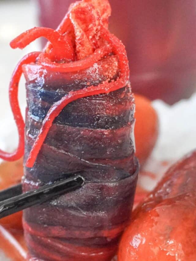 close up view of chamoy pickle surrounded by marinated pickles