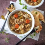 overhead view of a bowl of chicken noodle soup