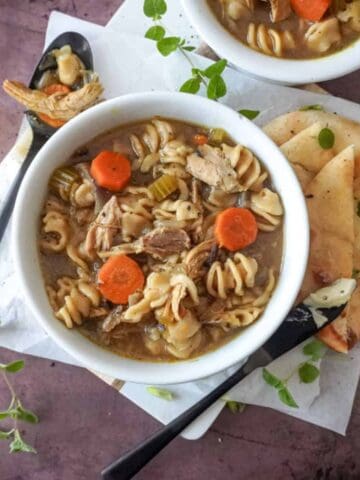 overhead view of a bowl of chicken noodle soup