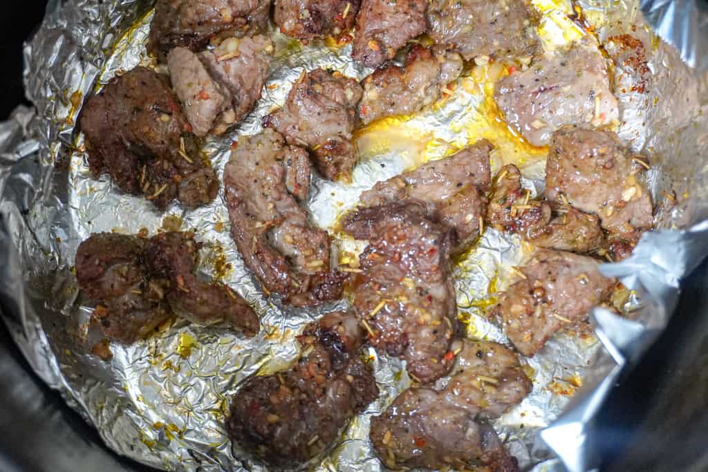 close up view of steak bites in an air fryer