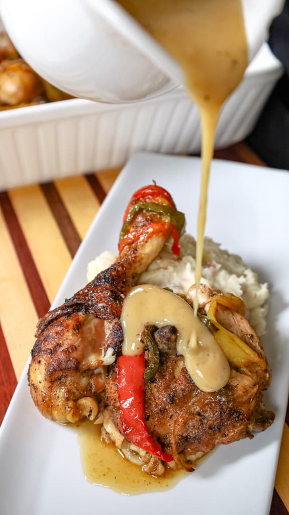 pouring gravy over plated chicken