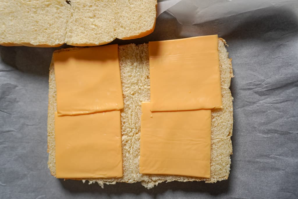 slices of cheese added to Hawaiian rolls
