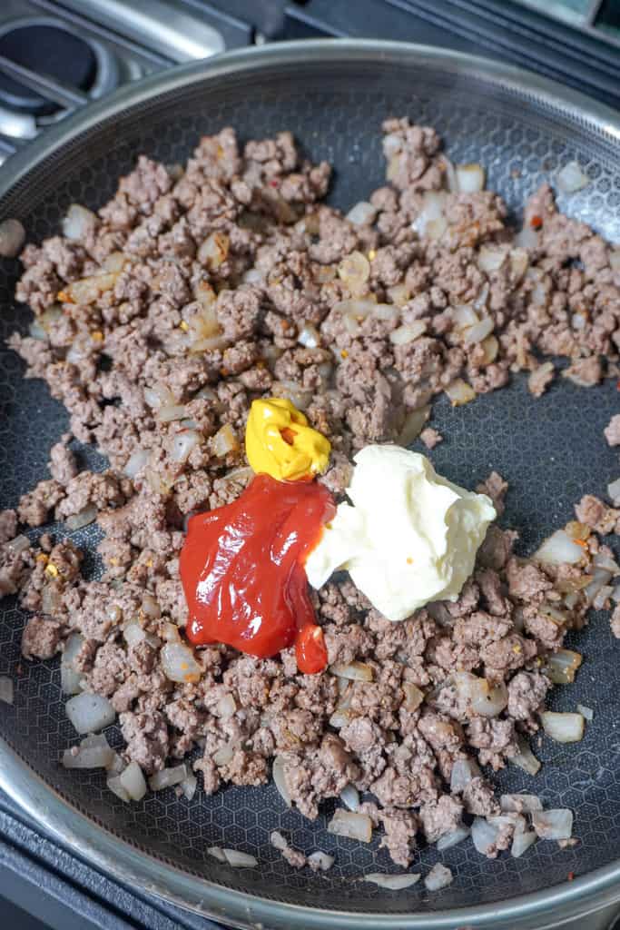 seasoned ground beef mixture cooking in a skillet