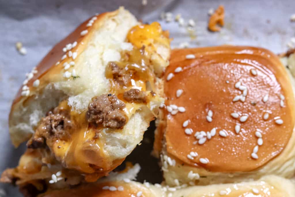 close up view of cheeseburger sliders on Hawaiian rolls