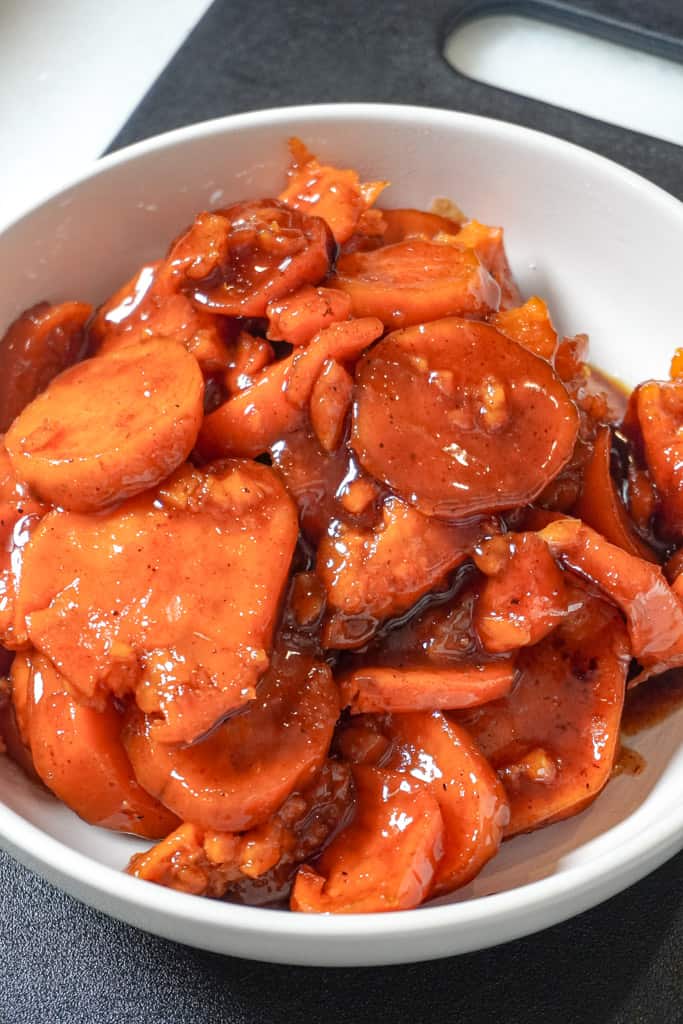 Candied sweet potatoes in a white bowl