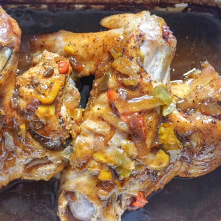 close up view of smothered turkey wings in a baking dish
