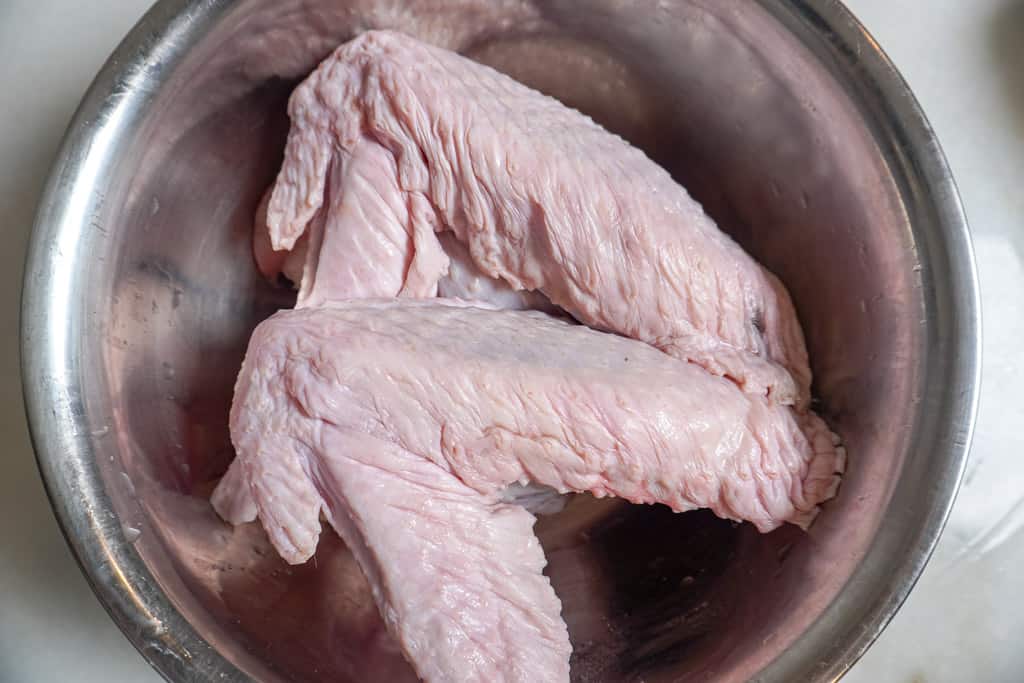 raw turkey legs in a bowl