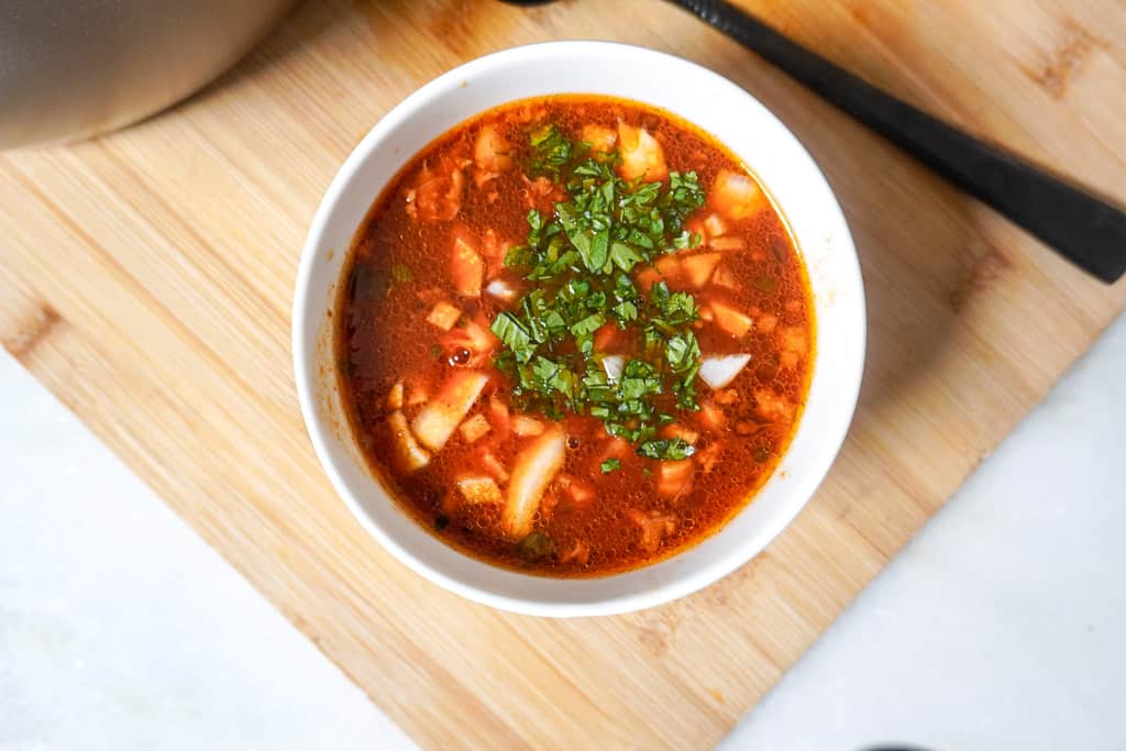 a bowl of consome for birria tacos