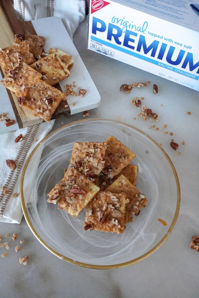 plated toffee cookies with a package of saltine crackers in the background