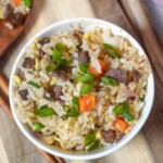 close up view of steak fried rice garnished with green onions