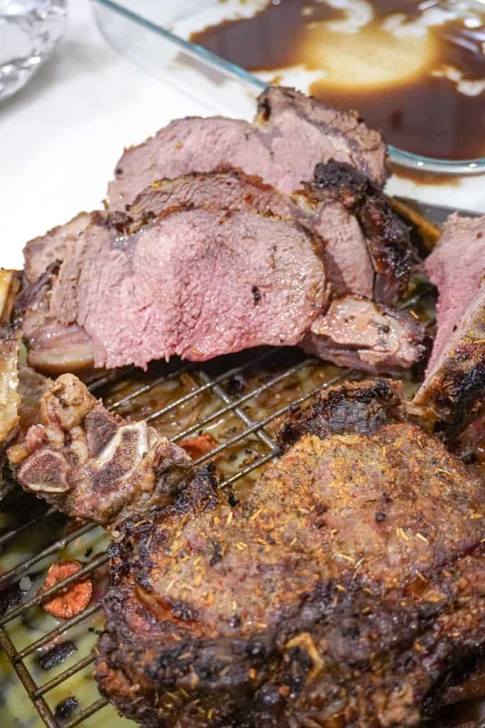 sliced ribeye roast on a cooling rack