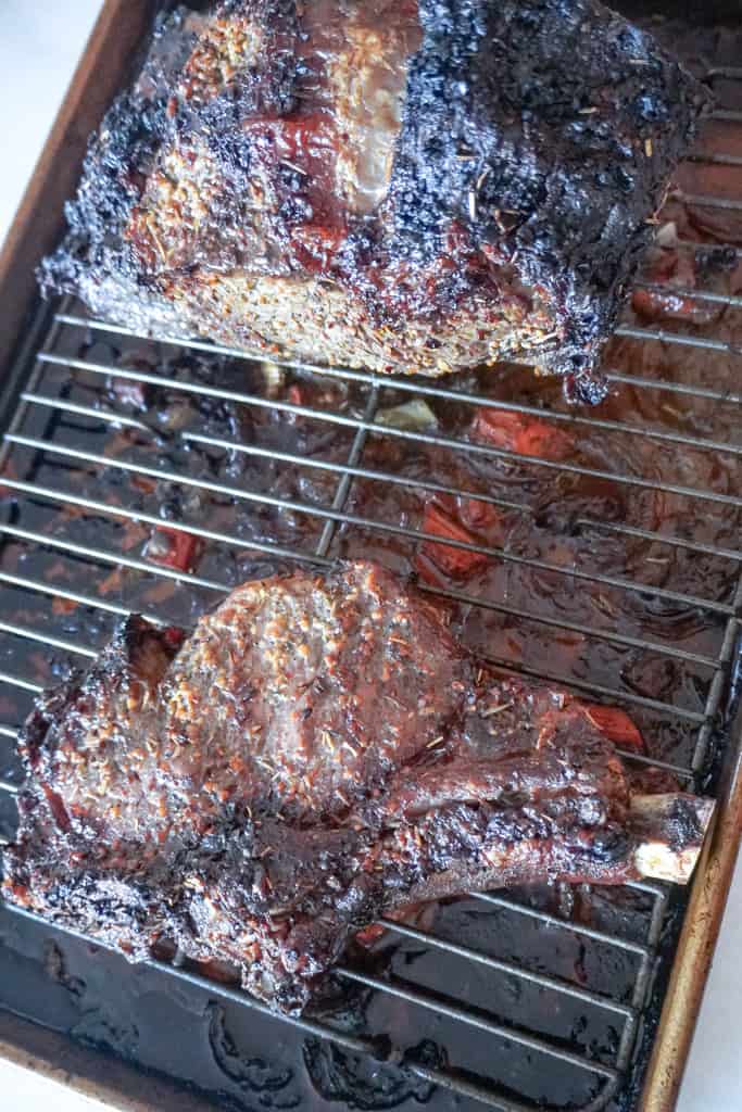 cooked ribeye roast resting on a wire rack